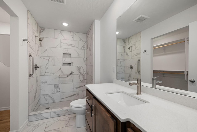 full bathroom with toilet, marble finish floor, visible vents, a shower stall, and vanity