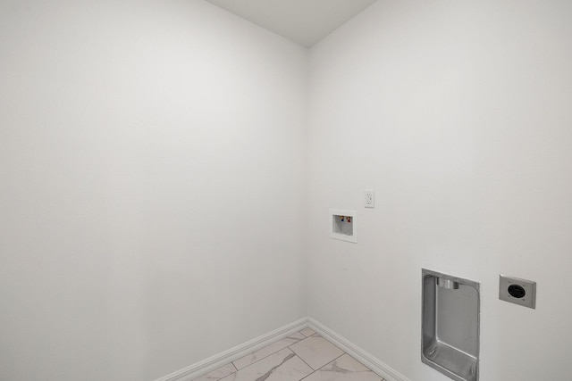 washroom featuring baseboards, marble finish floor, washer hookup, hookup for an electric dryer, and laundry area
