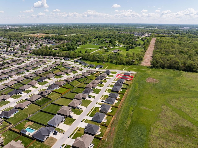 birds eye view of property featuring a view of trees and a residential view