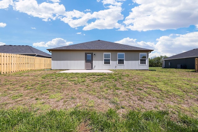 rear view of property with a patio area, fence, and a lawn