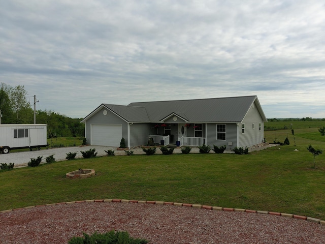 ranch-style home with a porch, a front yard, an attached garage, and driveway