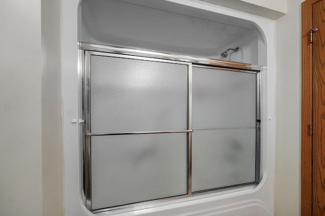 full bath featuring shower / bath combination with glass door