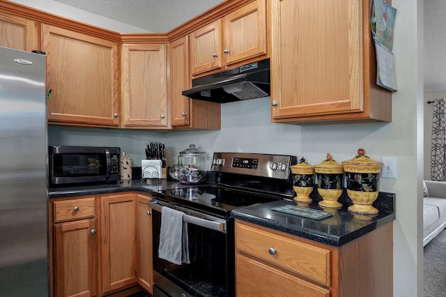 kitchen featuring under cabinet range hood, stainless steel appliances, and brown cabinetry