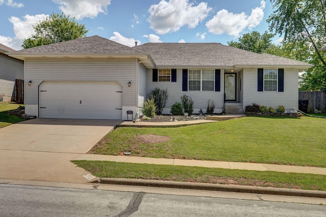 ranch-style house featuring fence, driveway, a garage, a front lawn, and a shingled roof