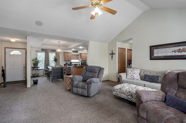 living room featuring vaulted ceiling, light colored carpet, baseboards, and ceiling fan
