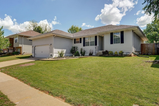 ranch-style house with driveway, an attached garage, fence, and a front yard