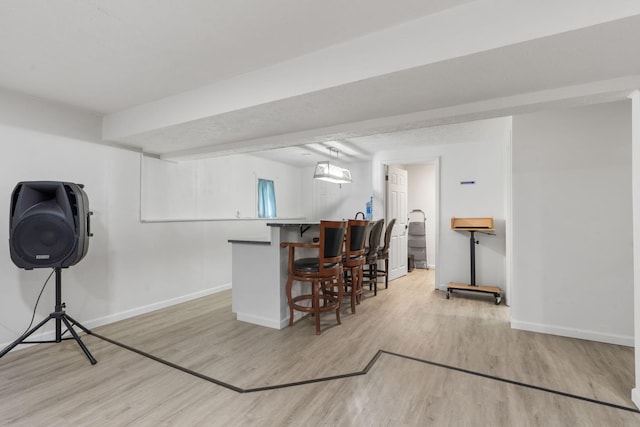 bar with baseboards and light wood-style flooring