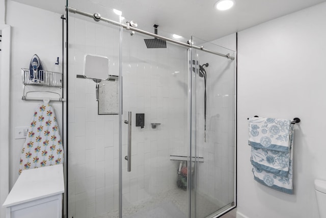 bathroom featuring a stall shower, toilet, and recessed lighting