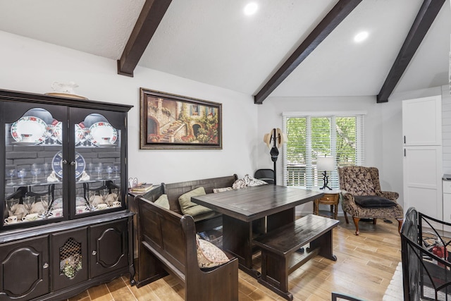 dining area with recessed lighting, lofted ceiling with beams, and light wood-style floors