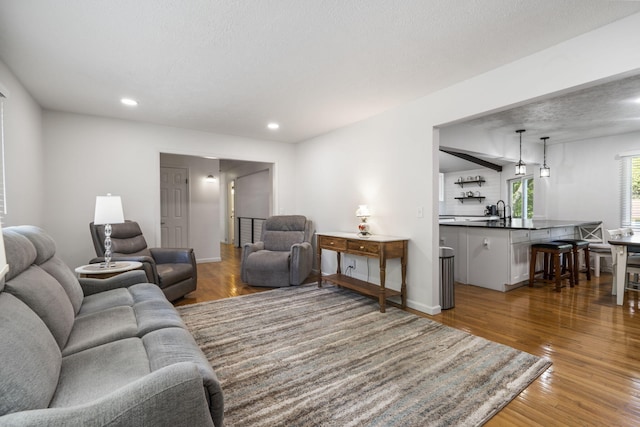 living room with baseboards, recessed lighting, and wood finished floors