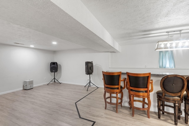 bar with baseboards, recessed lighting, a textured ceiling, and wood finished floors