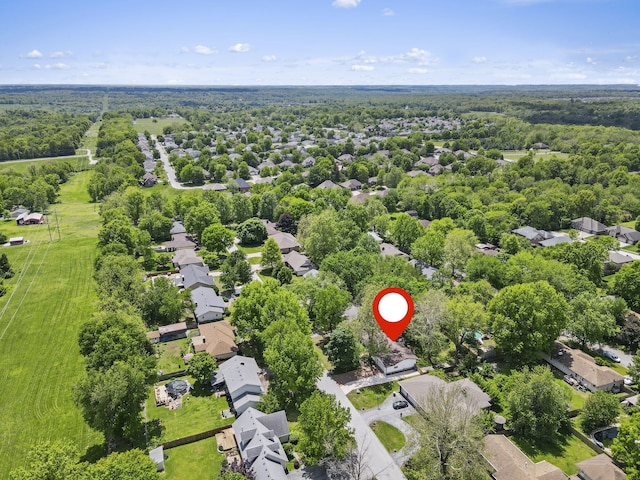 bird's eye view featuring a wooded view and a residential view