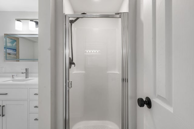 bathroom with a shower stall and vanity