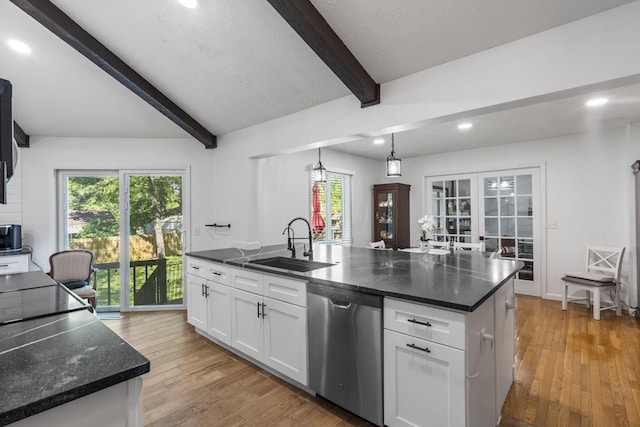 kitchen with light wood finished floors, a sink, white cabinetry, stainless steel dishwasher, and beamed ceiling