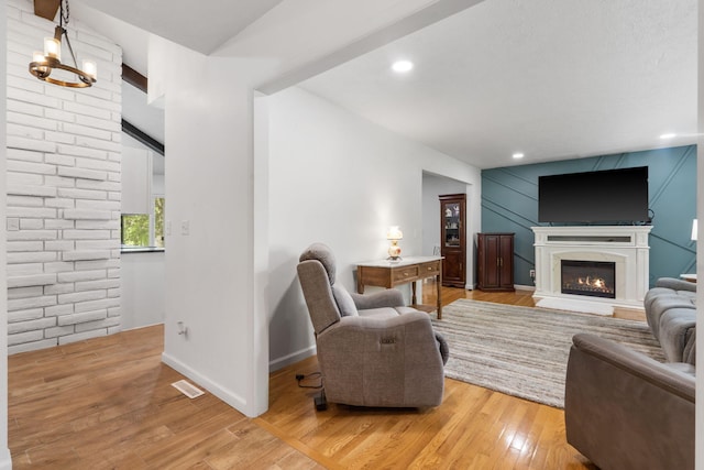living room with visible vents, recessed lighting, light wood finished floors, a premium fireplace, and baseboards