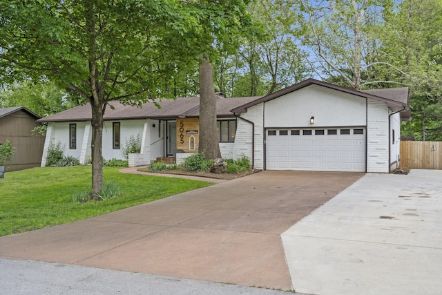 ranch-style home with a front yard, an attached garage, fence, and driveway