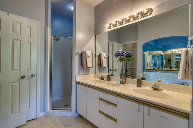 813 Holiday Rdg Unit H-11, Branson, MO 65616 - bathroom featuring double vanity, marble finish floor, a shower stall, and a sink