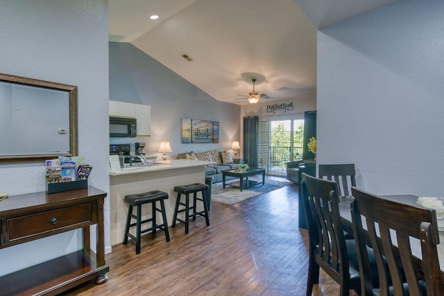 813 Holiday Rdg Unit H-11, Branson, MO 65616 - dining space with vaulted ceiling, wood finished floors, a ceiling fan, and a textured wall