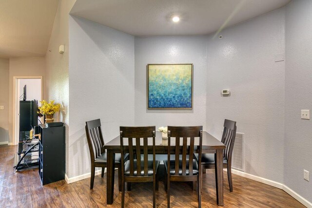 813 Holiday Rdg Unit H-11, Branson, MO 65616 - dining space with baseboards, visible vents, a textured wall, and wood finished floors