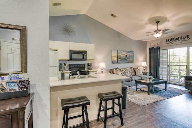 813 Holiday Rdg Unit H-11, Branson, MO 65616 - kitchen featuring black appliances, open floor plan, visible vents, and vaulted ceiling