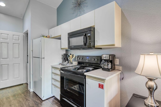 813 Holiday Rdg Unit H-11, Branson, MO 65616 - kitchen with black appliances, dark wood-type flooring, a textured wall, white cabinetry, and light countertops
