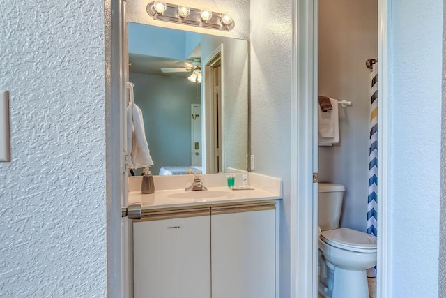 813 Holiday Rdg Unit H-11, Branson, MO 65616 - bathroom with toilet, vanity, ceiling fan, and a textured wall