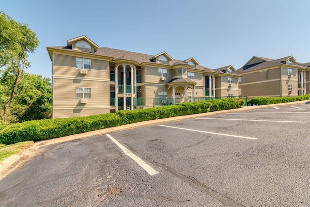 813 Holiday Rdg Unit H-11, Branson, MO 65616 - view of building exterior with fence and uncovered parking