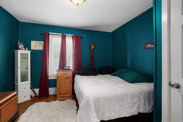 541 S Warren Ave, Springfield, MO 65806 - bedroom with a textured ceiling and wood finished floors