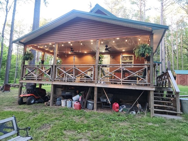 748 Puckett Rd, Anderson, MO 64831 - back of property with a ceiling fan, a lawn, a deck, and stairs