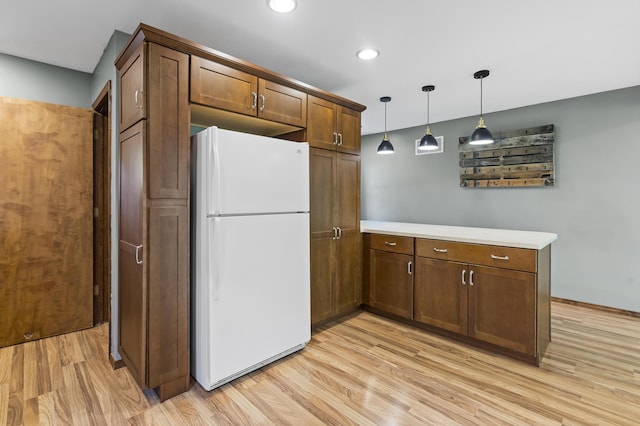408 Meadowlark Rd, Branson West, MO 65737 - kitchen featuring pendant lighting, freestanding refrigerator, light wood-style flooring, and light countertops