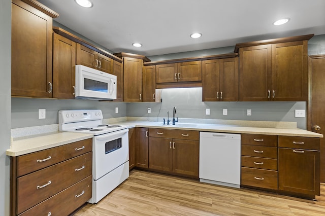 408 Meadowlark Rd, Branson West, MO 65737 - kitchen featuring light wood finished floors, white appliances, light countertops, and a sink