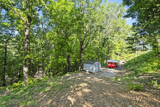 408 Meadowlark Rd, Branson West, MO 65737 - view of yard featuring an outdoor structure and a storage shed