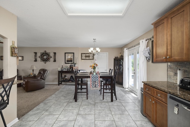 dining room featuring marble finish floor and an inviting chandelier