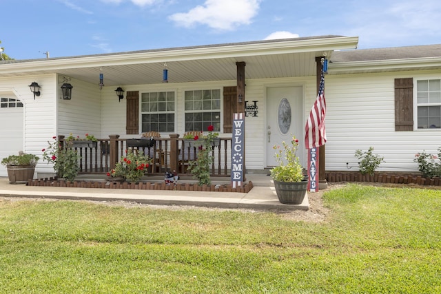 single story home featuring a porch, a front lawn, and a garage