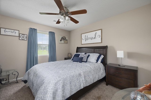 carpeted bedroom featuring a textured ceiling, baseboards, and a ceiling fan