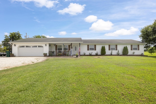 ranch-style home featuring driveway, covered porch, a garage, and a front yard