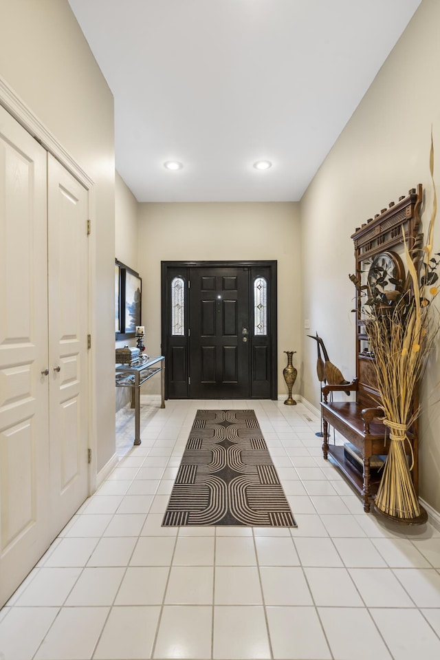 entryway with light tile patterned floors and recessed lighting