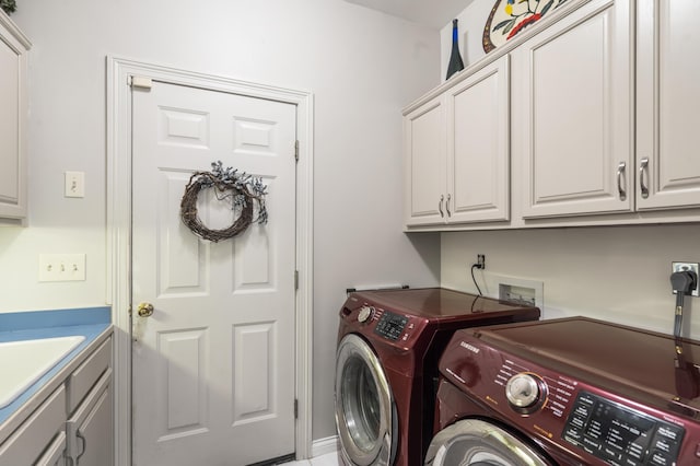 washroom with washing machine and clothes dryer and cabinet space