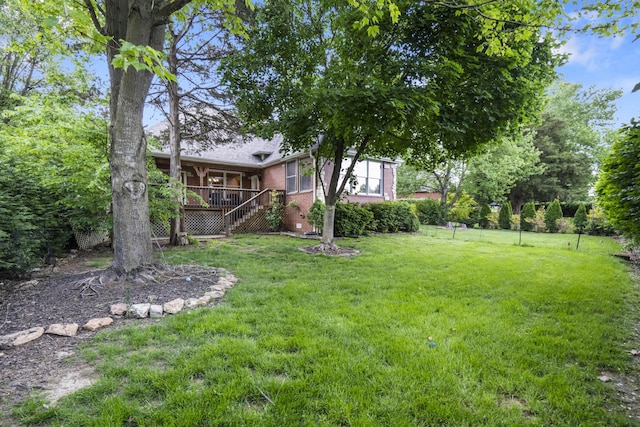 view of grassy yard featuring stairway