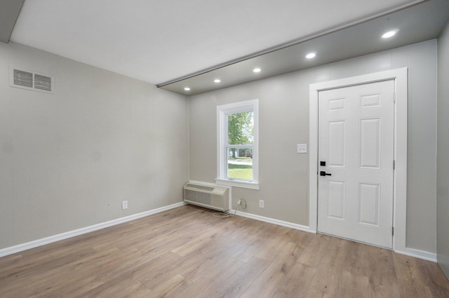 entryway with light wood-style flooring, a wall mounted air conditioner, visible vents, and recessed lighting