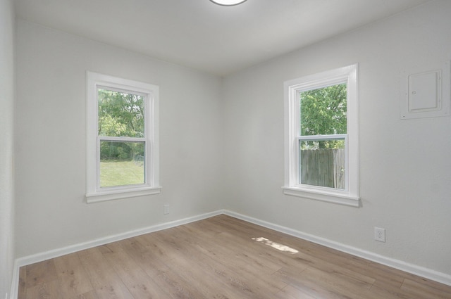 unfurnished room with baseboards and wood finished floors