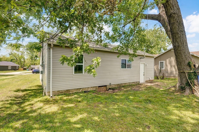 view of property exterior with a lawn
