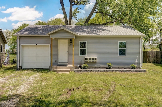 single story home featuring a front lawn, a shingled roof, an attached garage, and fence