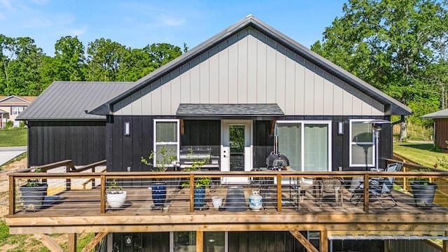 back of property featuring a deck and board and batten siding