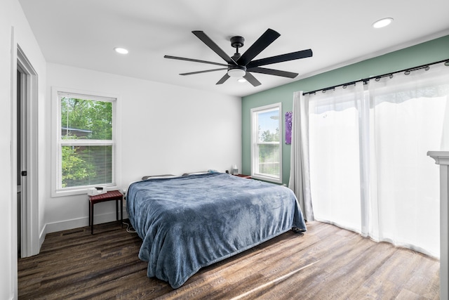 bedroom featuring wood finished floors, recessed lighting, ceiling fan, and baseboards