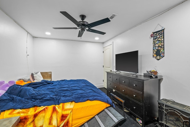 bedroom featuring recessed lighting, carpet flooring, a ceiling fan, and a wood stove