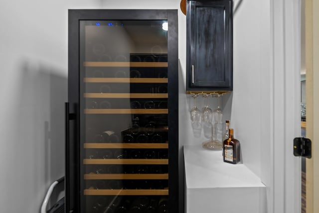 wine area with beverage cooler and a dry bar