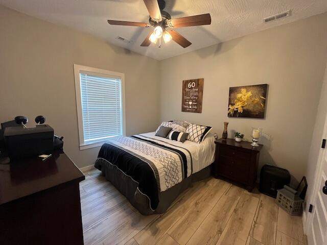 bedroom featuring light wood-type flooring and a ceiling fan