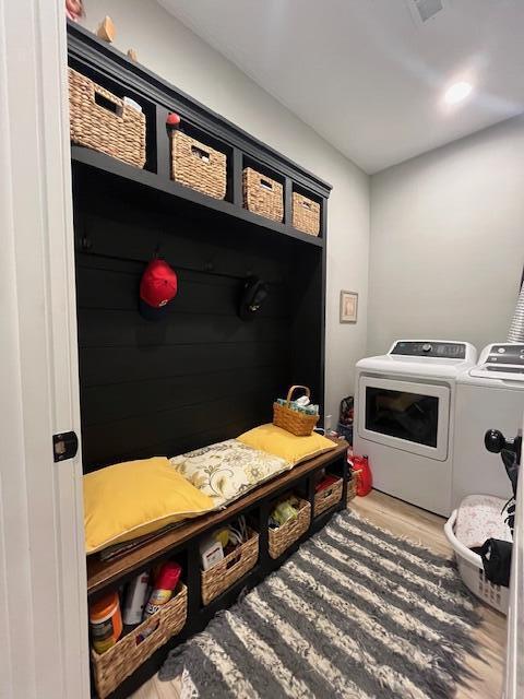 mudroom featuring independent washer and dryer and wood finished floors