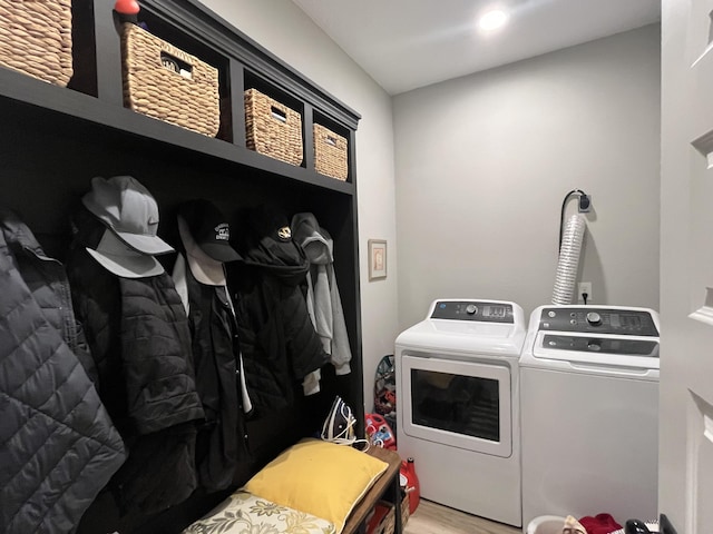 washroom with separate washer and dryer, wood finished floors, and recessed lighting